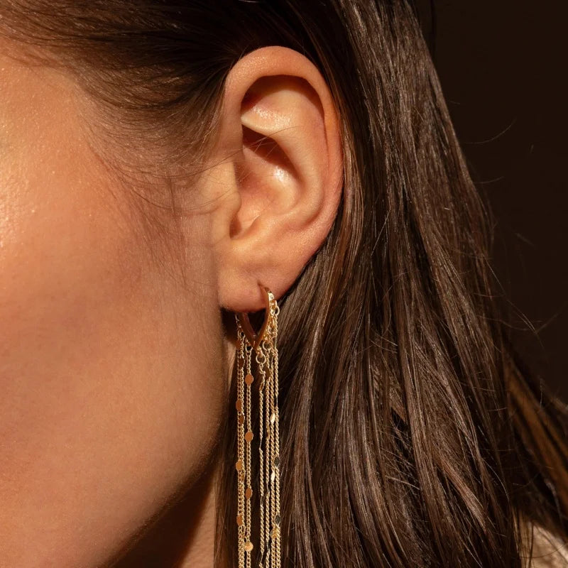 Pompon earrings enhancing the face