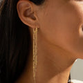 Pompon earrings enhancing the face