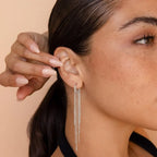 Pompon earrings enhancing the face