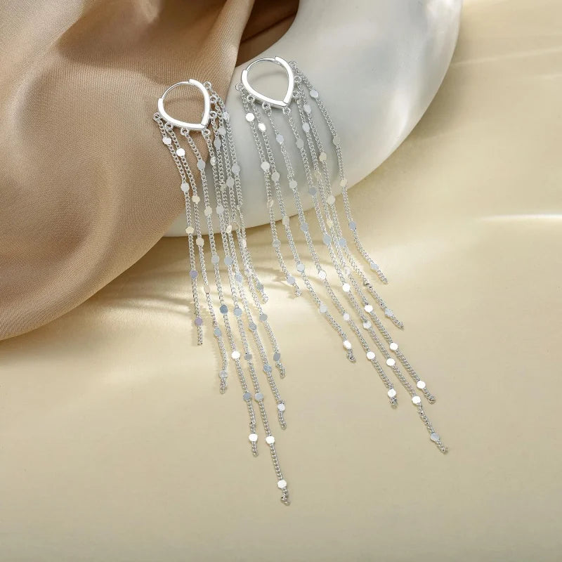 Pompon earrings enhancing the face