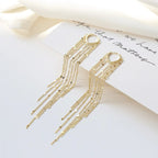 Pompon earrings enhancing the face