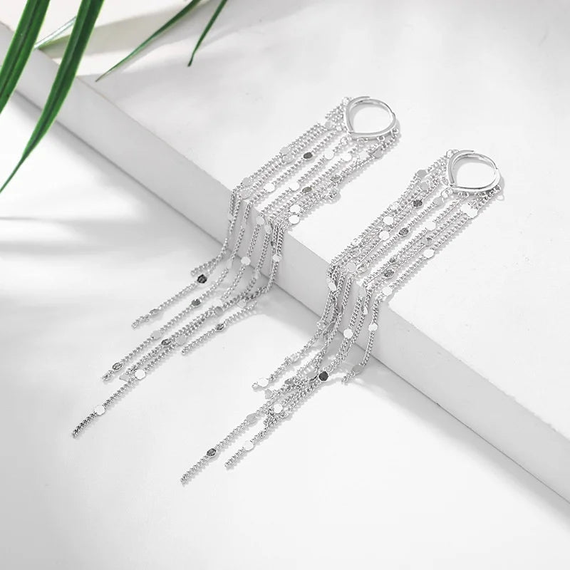 Pompon earrings enhancing the face