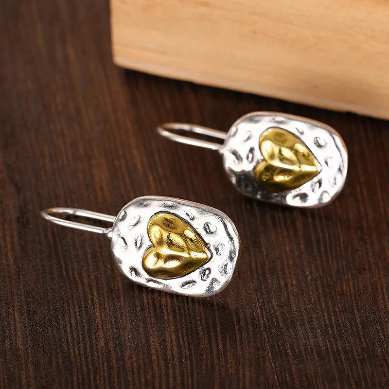 Silver and gold colored heart earrings