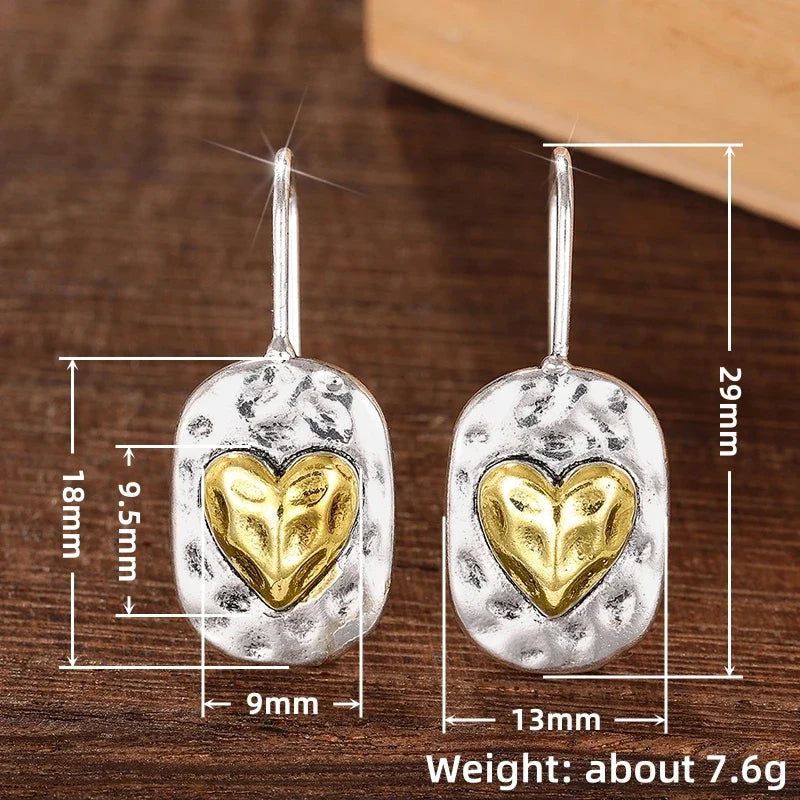 Silver and gold colored heart earrings