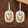Silver and gold colored heart earrings