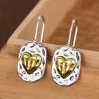 Silver and gold colored heart earrings