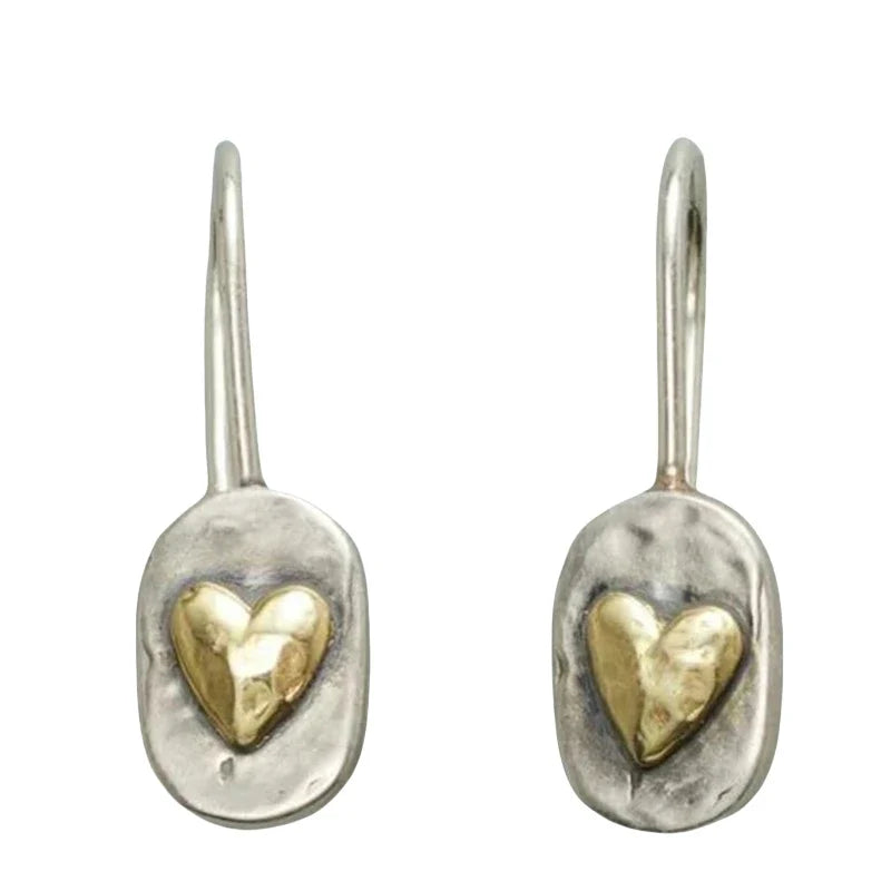 Silver and gold colored heart earrings