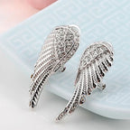 Dangling angel wing earrings with silver rhinestones