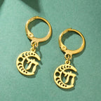 Gold dangling earrings with the Chai symbol of life on a crescent moon