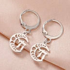 Silver dangling earrings with the Chai symbol of life on a crescent moon