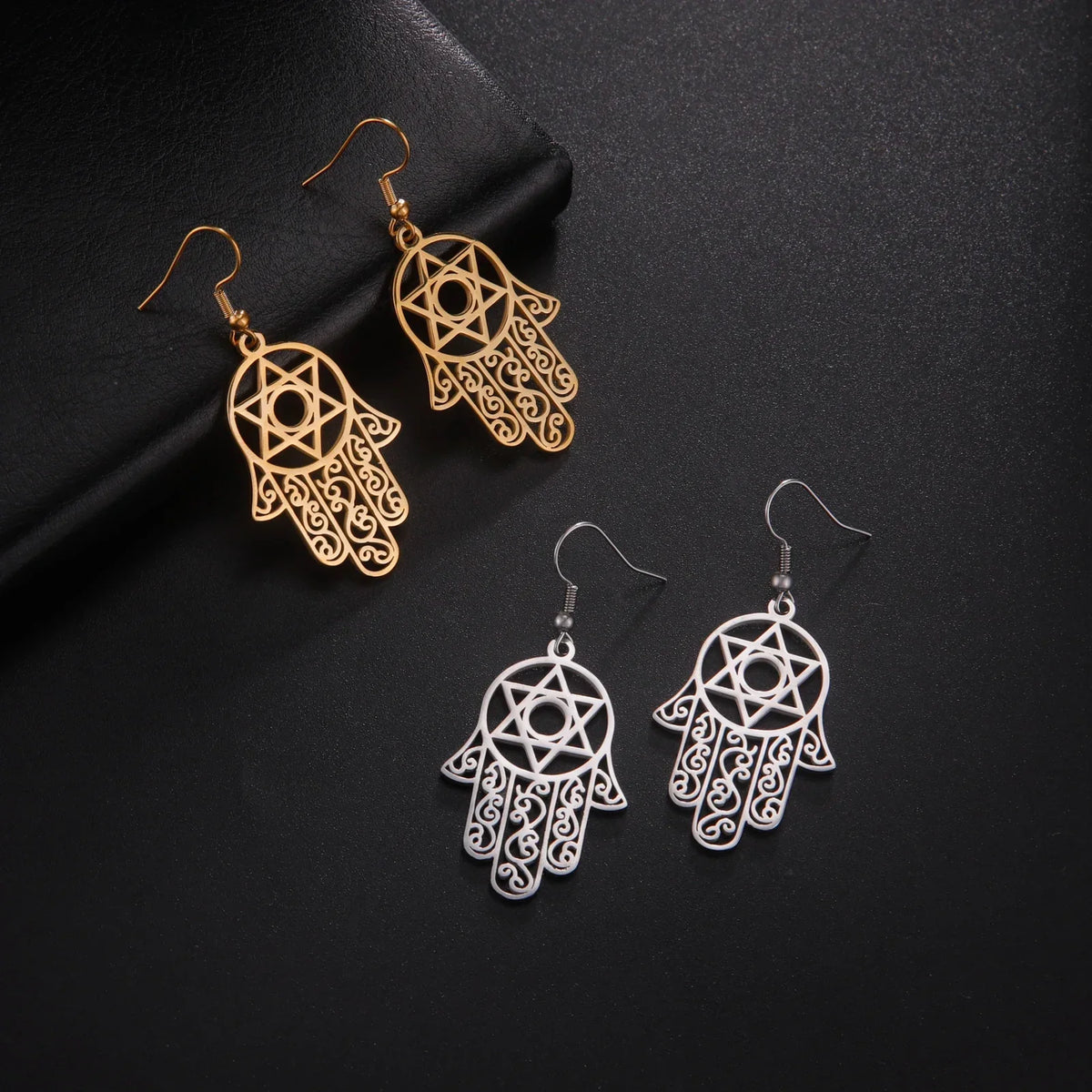 Dangling earrings with the Jewish protective symbol, Hamsa hand and Star of David