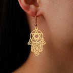Dangling earrings with the Jewish protective symbol, Hamsa hand and Star of David, gold