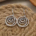 Drop earrings with engraved spiral