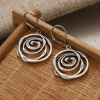 Drop earrings with engraved spiral