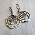 Drop earrings with engraved spiral