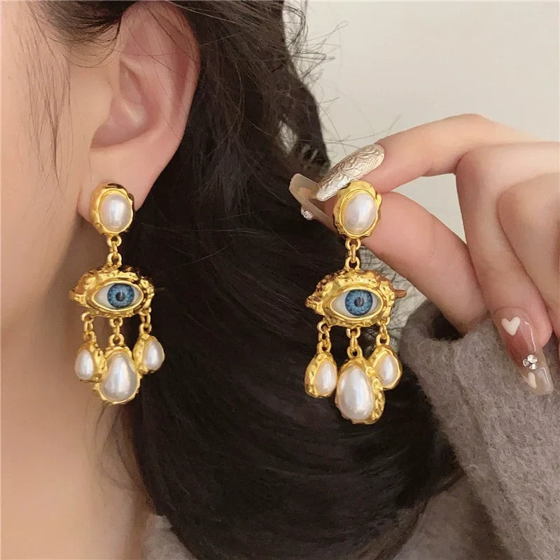 Blue Eye and Pearl Drop Earrings in gold