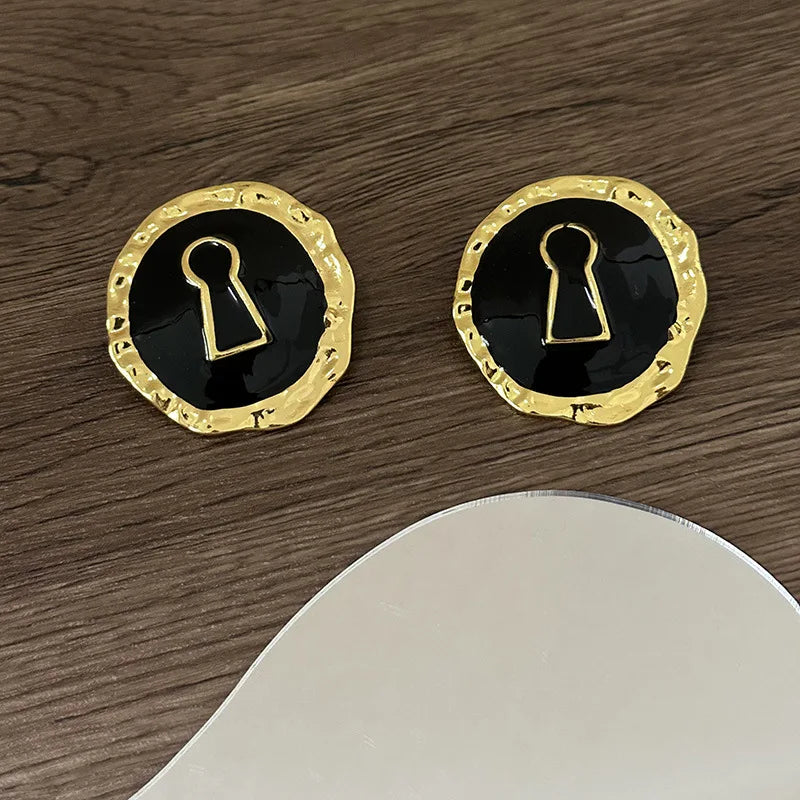 Round black key earrings