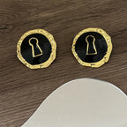 Round black key earrings