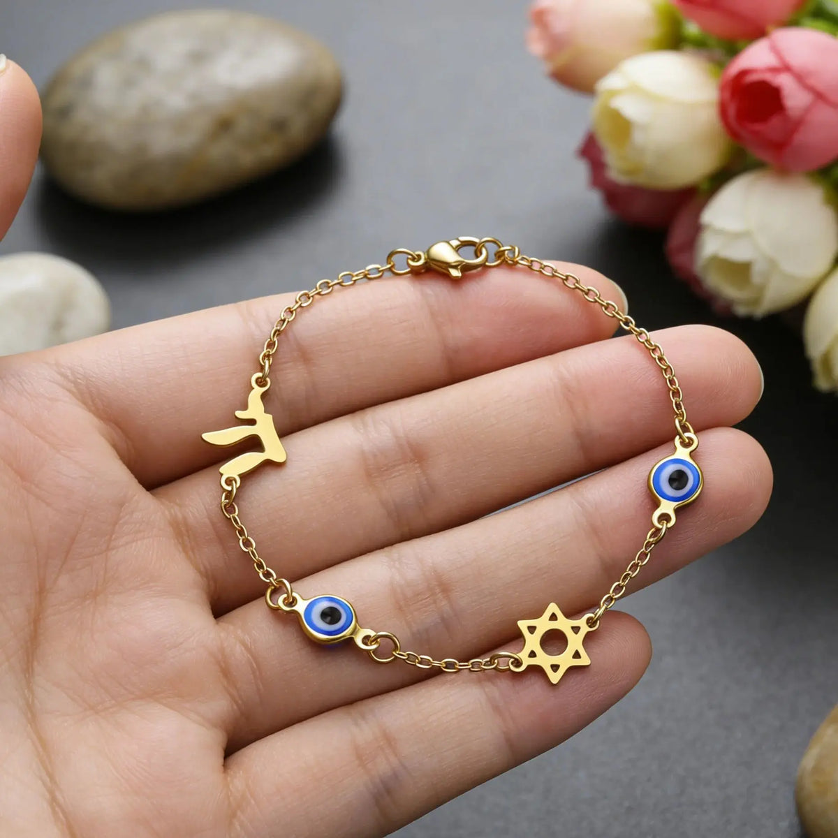 Bracelet with protection symbols: blue eye, Chai, and the Star of David in gold