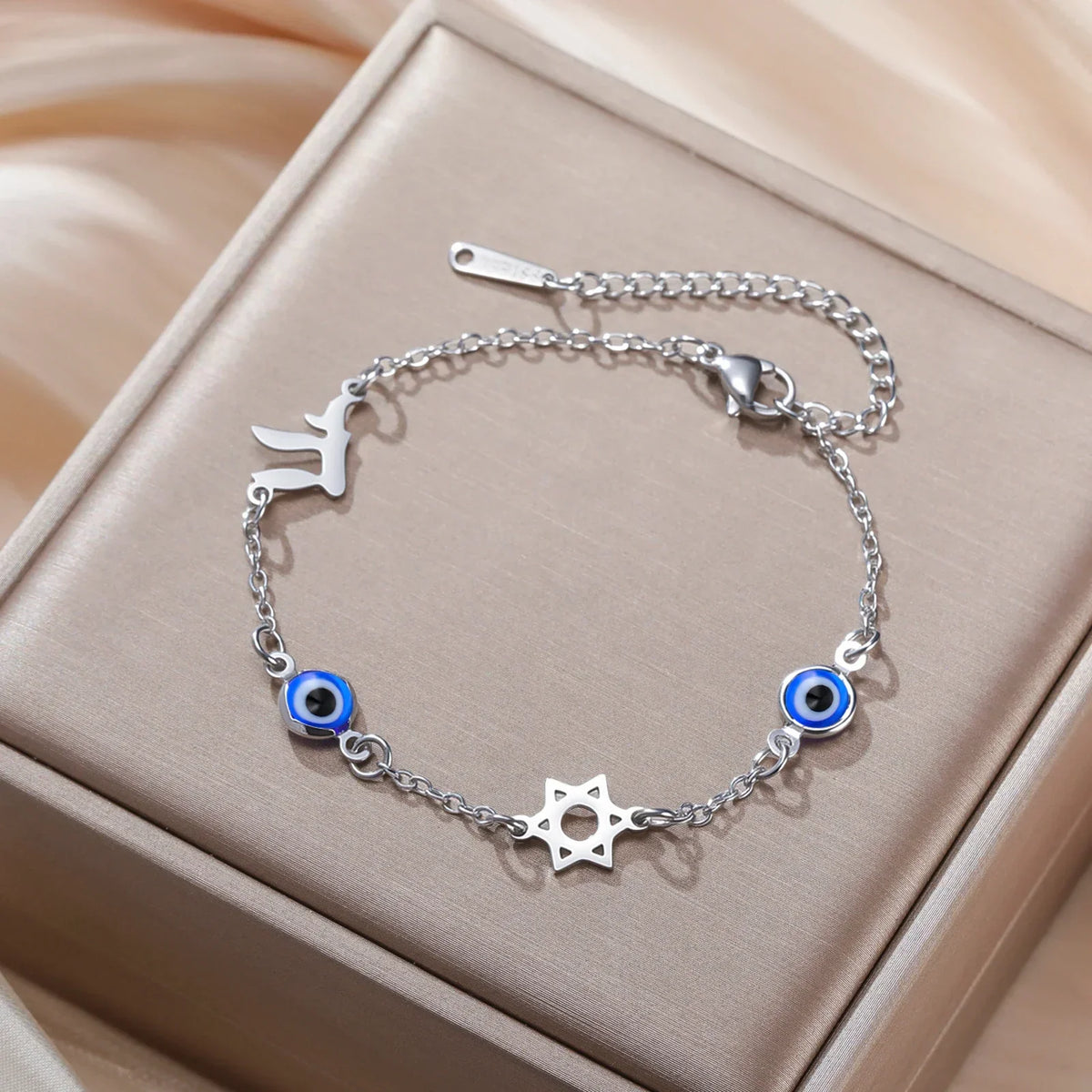 Bracelet with protection symbols: blue eye, Chai, and the Star of David in silver