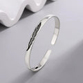 Open bangle bracelet with silver-plated feather