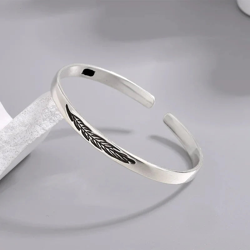 Open bangle bracelet with silver-plated feather