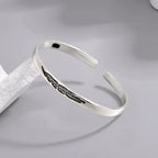 Open bangle bracelet with silver-plated feather