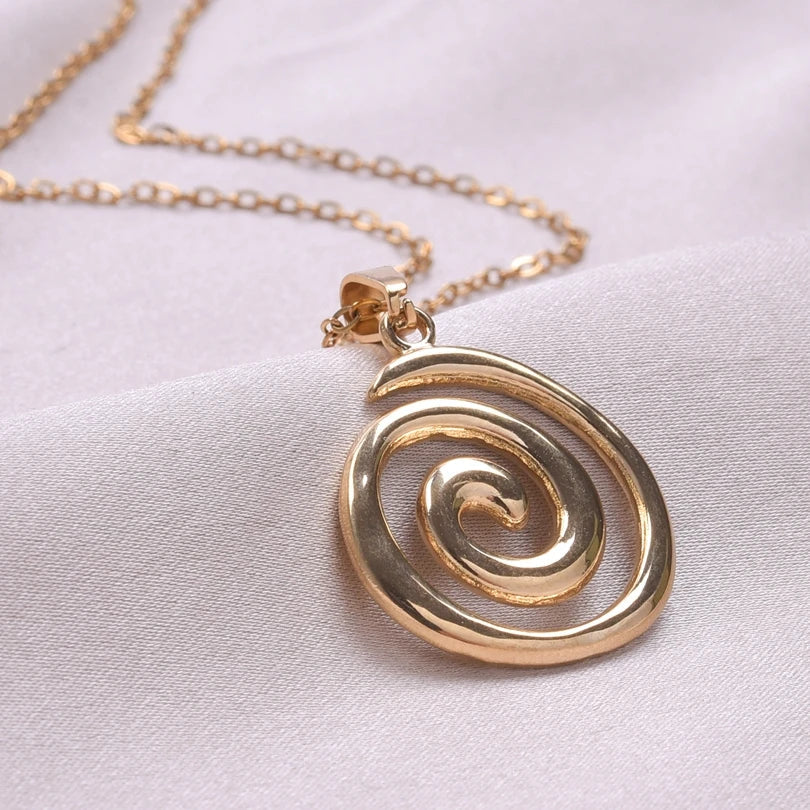 Necklace with large openwork spiral pendant in gold tone