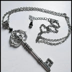 Necklace with key and skull pendant