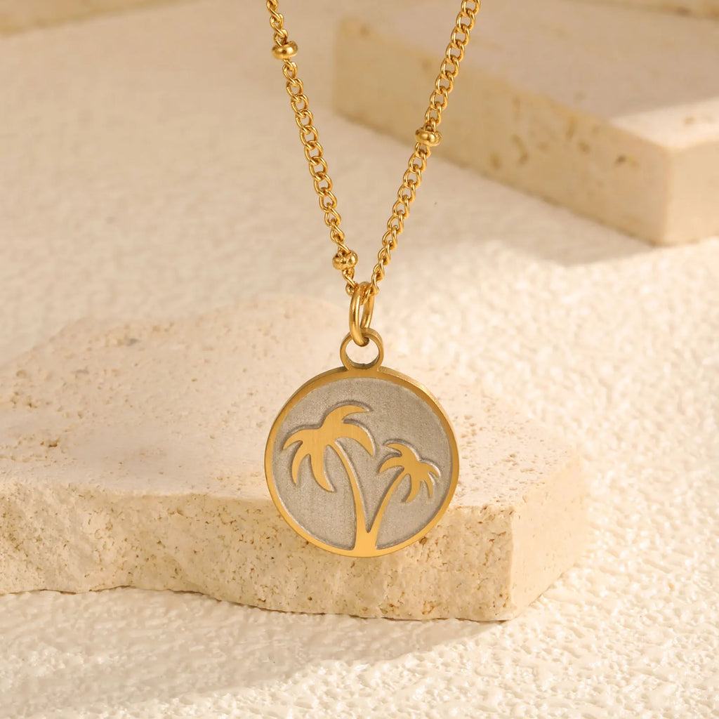 Necklace with round pendant and palm tree motif