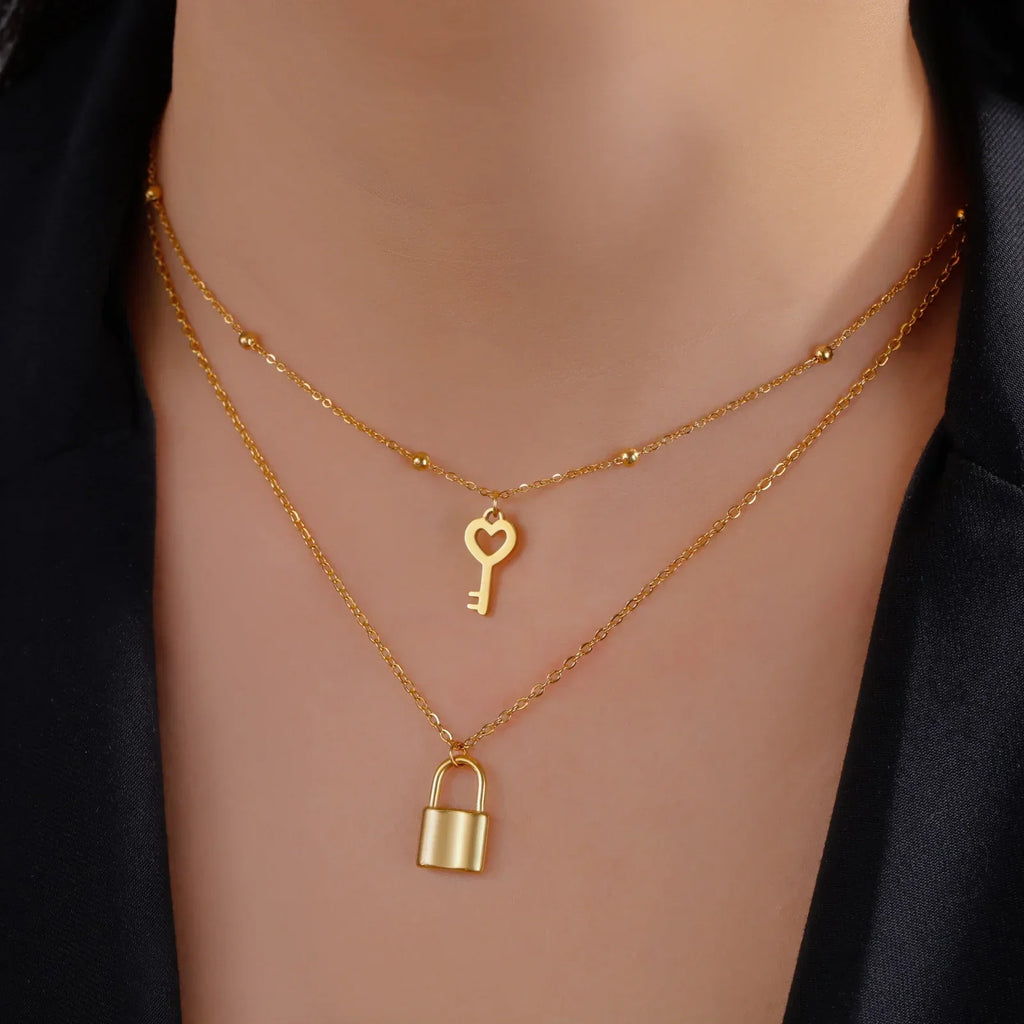 Double necklace with key and padlock pendant in gold tone