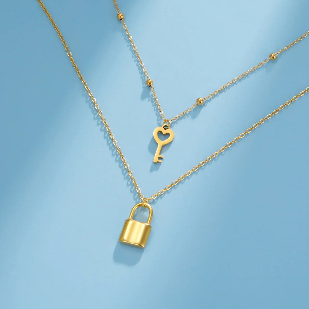 Double necklace with key and padlock pendant in gold tone