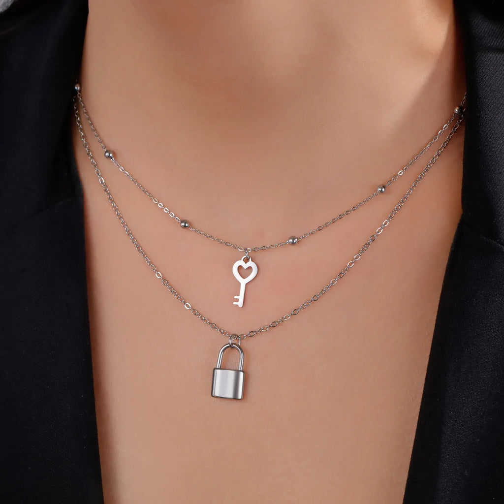 Double necklace with key and padlock pendant in silver tone