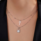 Double necklace with key and padlock pendant in silver tone