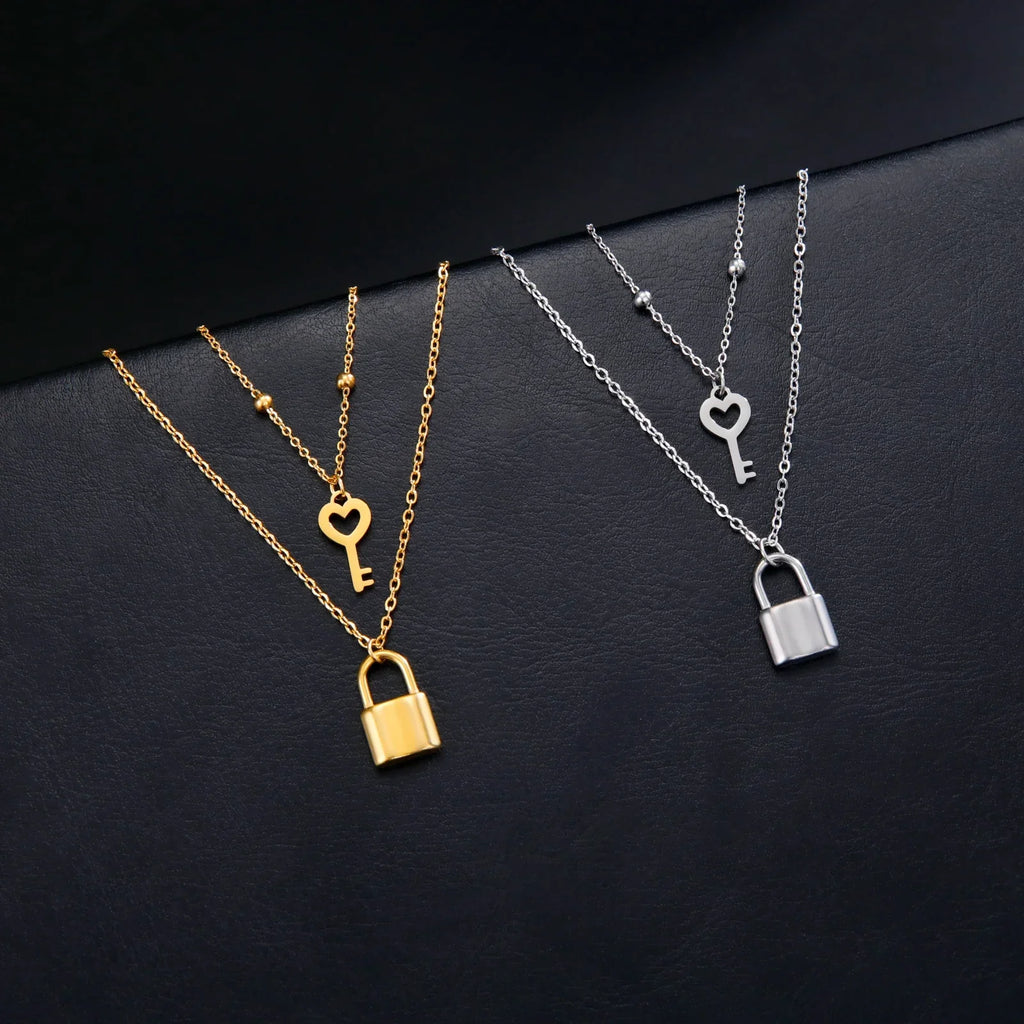 Double necklace with key and padlock pendant in gold tone