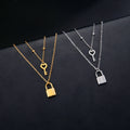 Double necklace with key and padlock pendant in gold tone