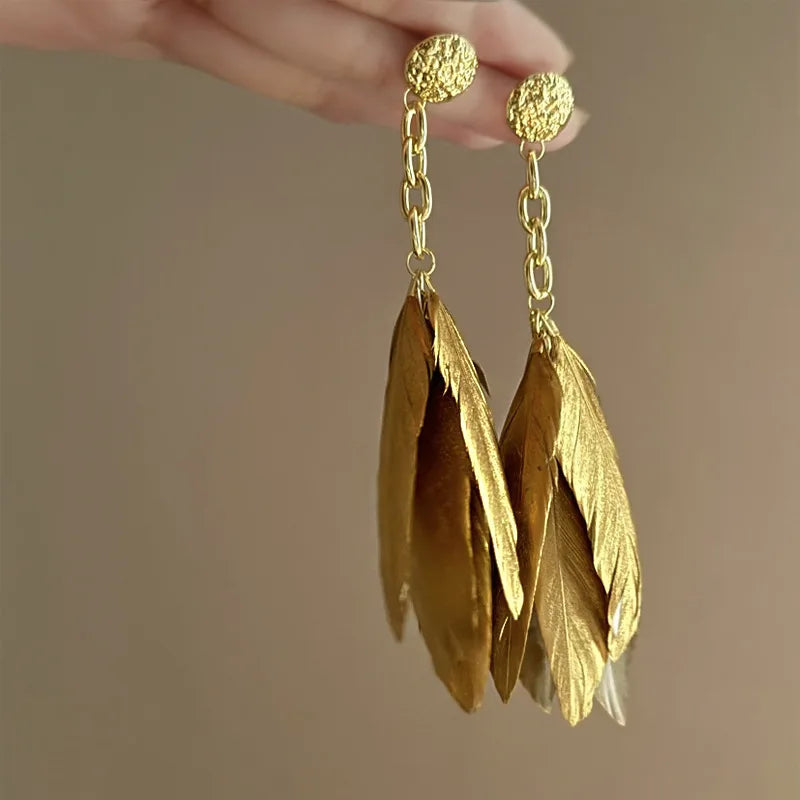 Large gold feather earrings