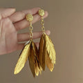 Large gold feather earrings
