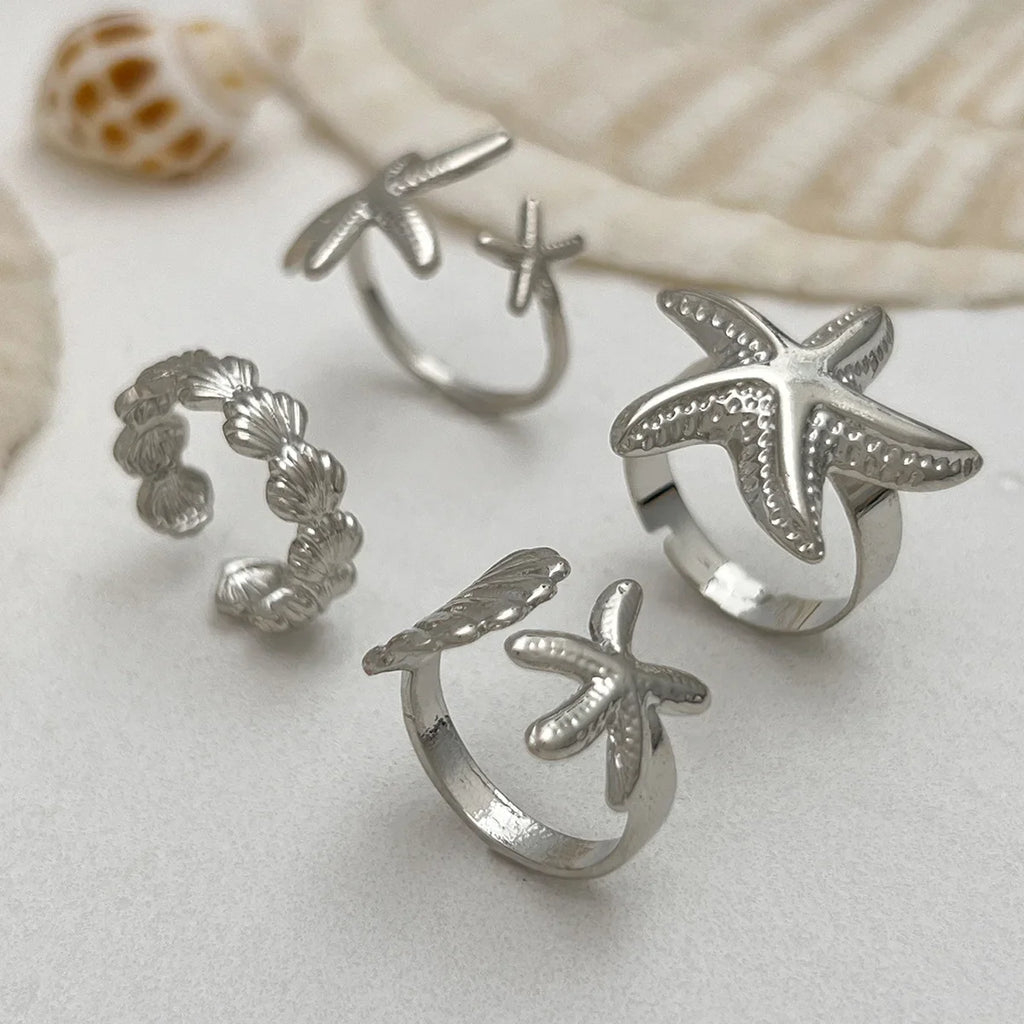 Set of 4 shell and starfish rings in silver