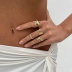 Set of 4 shell and starfish rings in gold